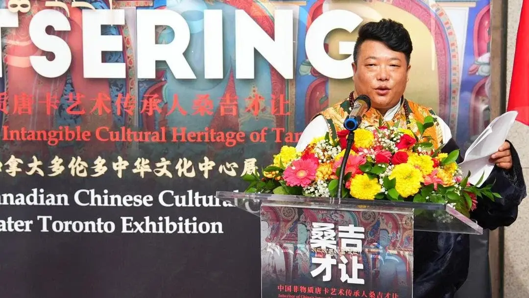 Thangka artist Sangji Cairang speaks at the opening