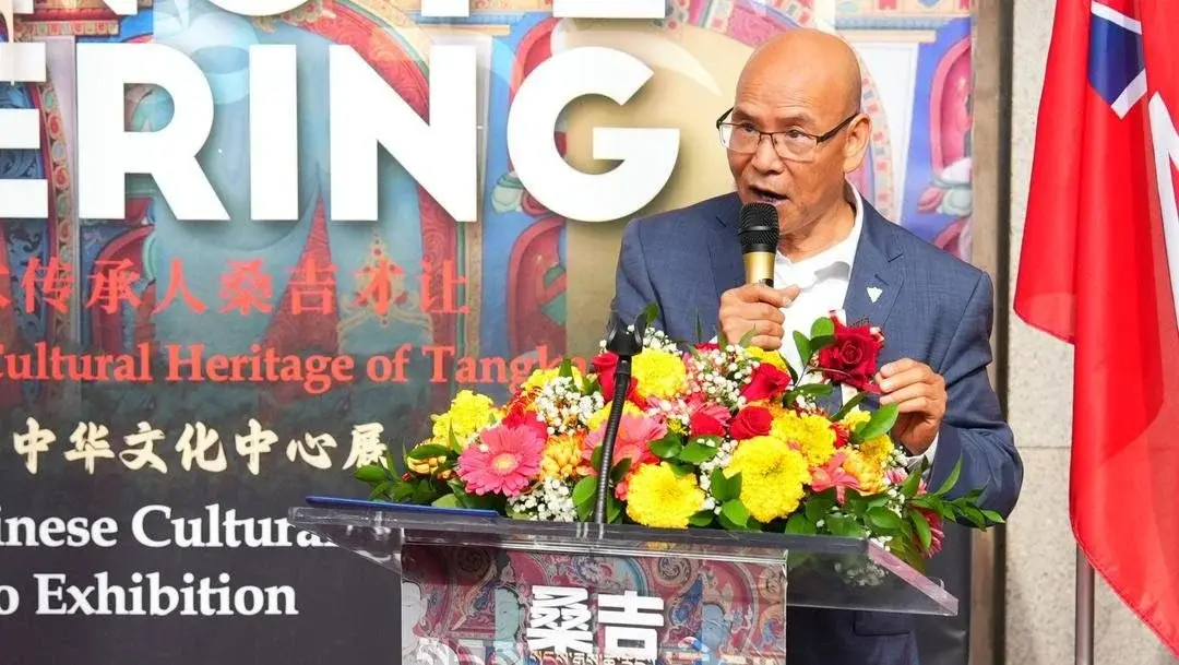 A guest of honour speaks at the Thangka exhibition opening